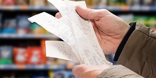 Man reading shopping receipt