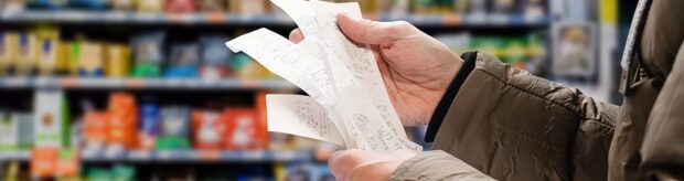 Man reading shopping receipt