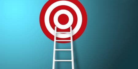 red and white target on blue background, with white ladder reaching up to the target