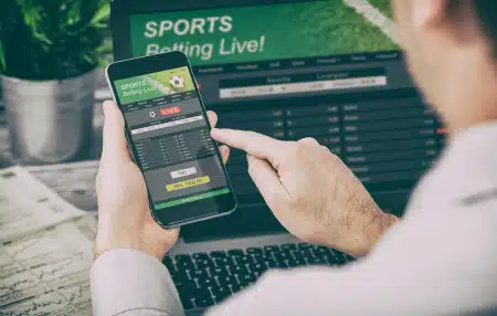 person placing a bet online on smartphone