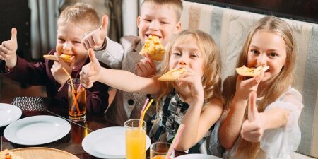 Kids eating pizza at a restaurant