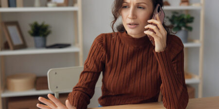 Woman on the phone looking confused
