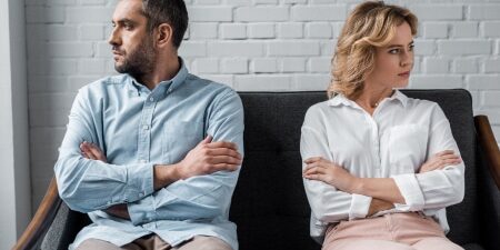 Man and woman separated on a sofa
