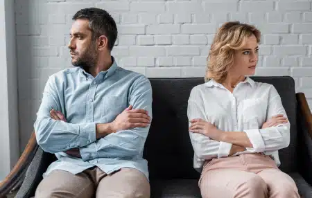 Man and woman separated on a sofa
