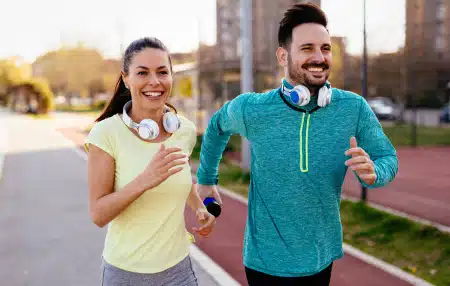 A couple running together outside