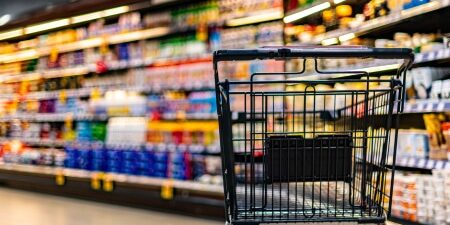 Image of a shopping trolley in an aisle at a supermarket