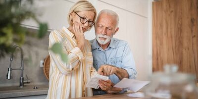 old couple reading a letter.