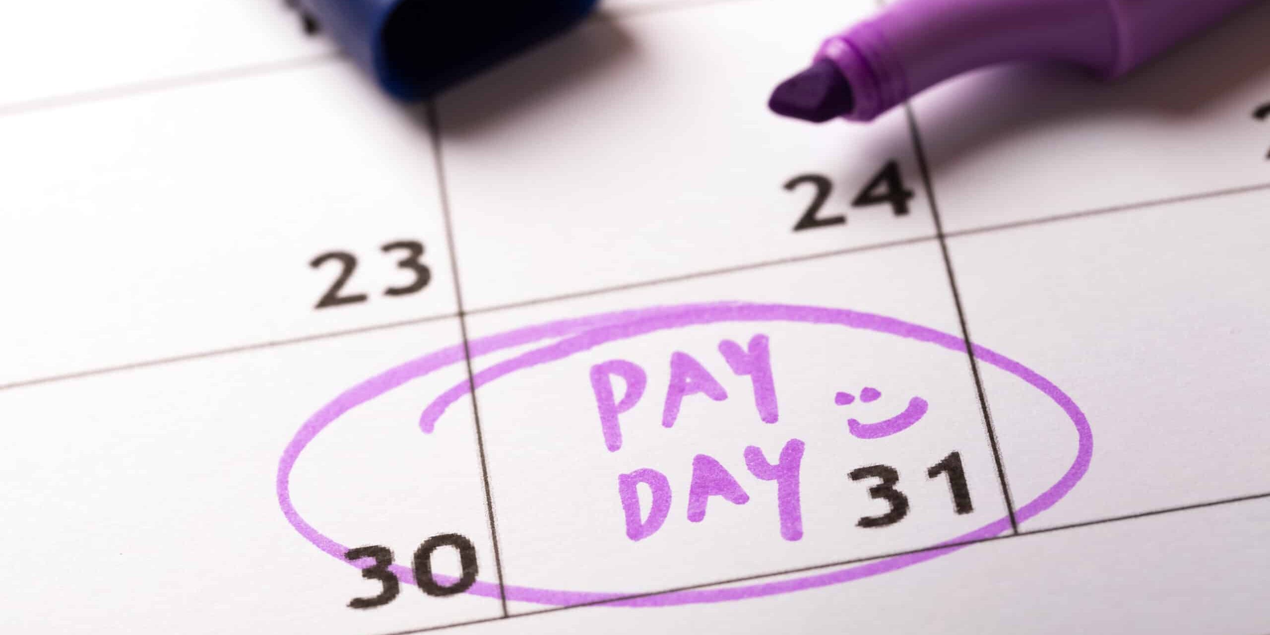 Calendar with "Pay Day" written on the 31st, highlighted in purple marker.