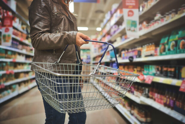 woman-shopping Cropped shot of a woman holding a basket while shopping at a grocery store