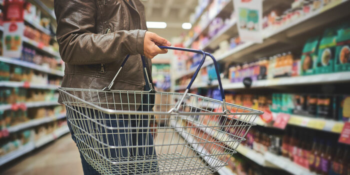 woman-shopping Cropped shot of a woman holding a basket while shopping at a grocery store